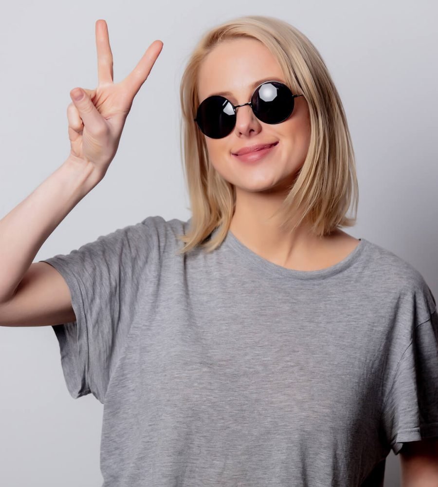 smiling-blonde-woman-in-sunglasses-on-white-backgr-MHZMJWC.jpg